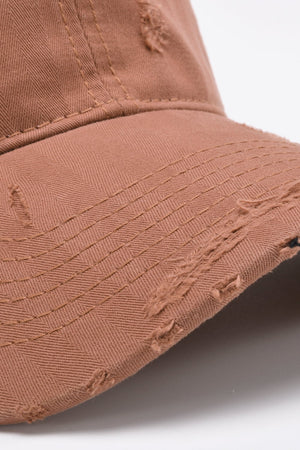 Coral baseball cap with distressed details and herringbone fabric texture.