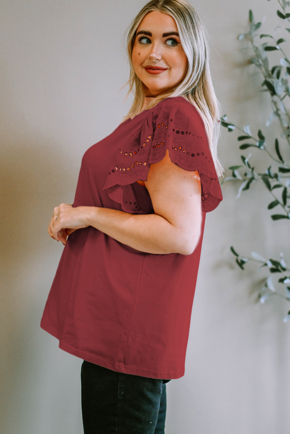 Burgundy eyelet flutter sleeve tee with scalloped hem detail.
