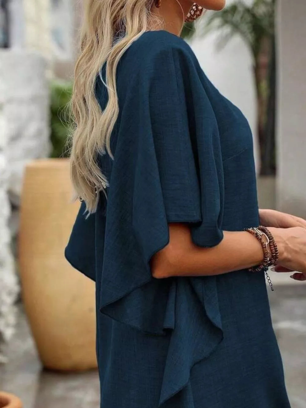 Dark navy ruffled sleeve V-neck mini dress with layered details.