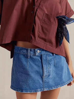Classic denim mini skort in light blue with button closure and casual styling.