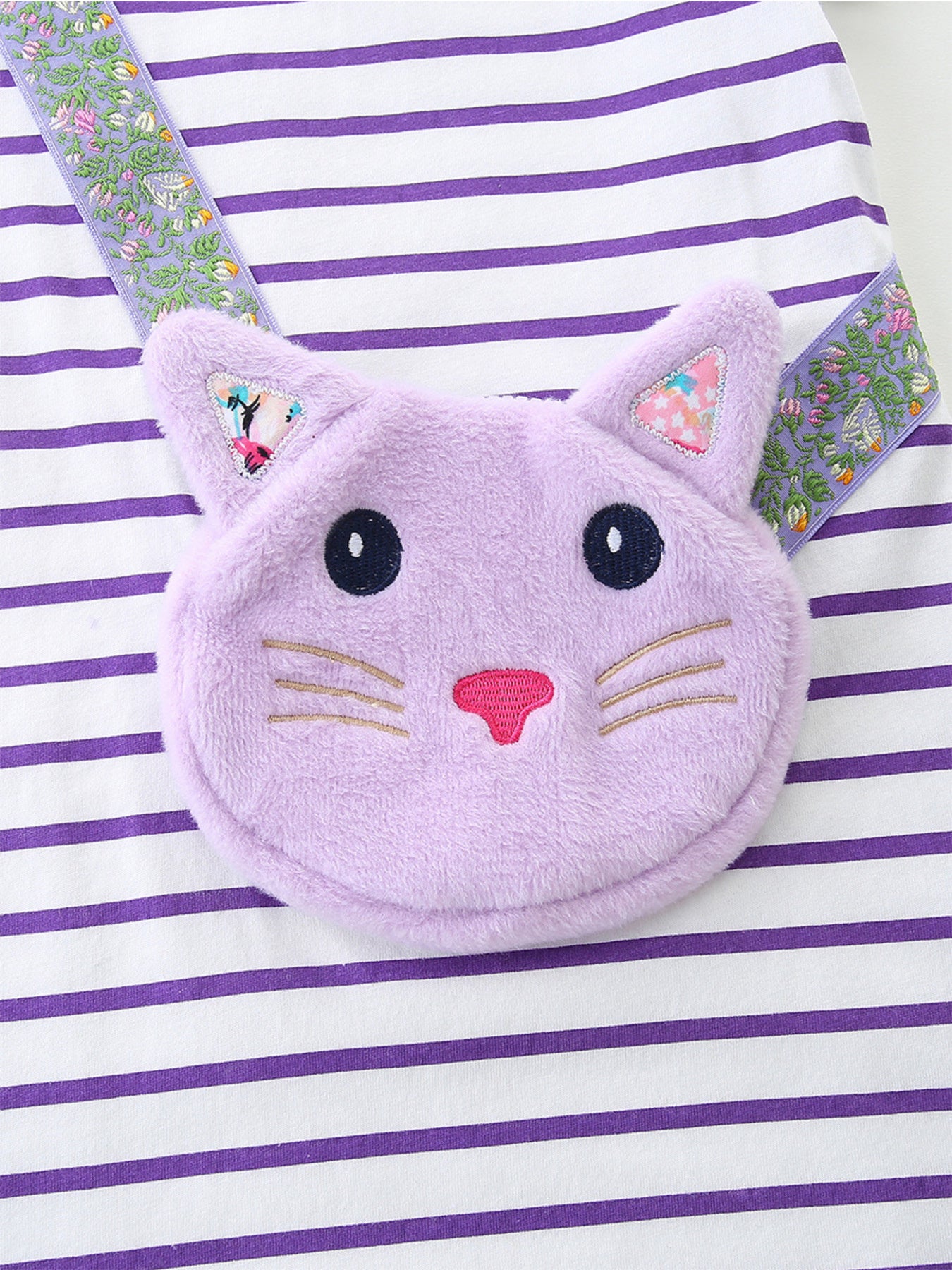 Baby dress with purple and white stripes, featuring a plush lavender cat face applique and floral ribbon straps.