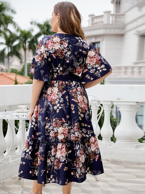 Navy floral midi dress with flutter sleeves and tiered ruffle hem.