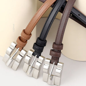 Slim cowhide leather belts in black, coffee brown, and brown with silver buckles.