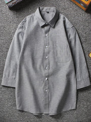 Grey button-up shirt with chest pocket and 3/4 sleeves
