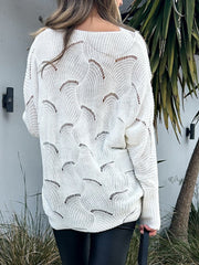 White openwork knit sweater with lace insets and a boat neckline.