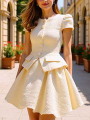 Textured cream button-down dress with puff sleeves and bubble hem skirt.
