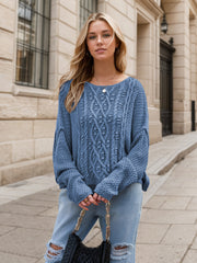 Dusty blue cable knit cocoon sweater with crew neck and bell sleeves.