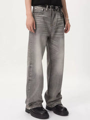 Men's vintage wash wide leg jeans in gray cotton, styled with a black belt.