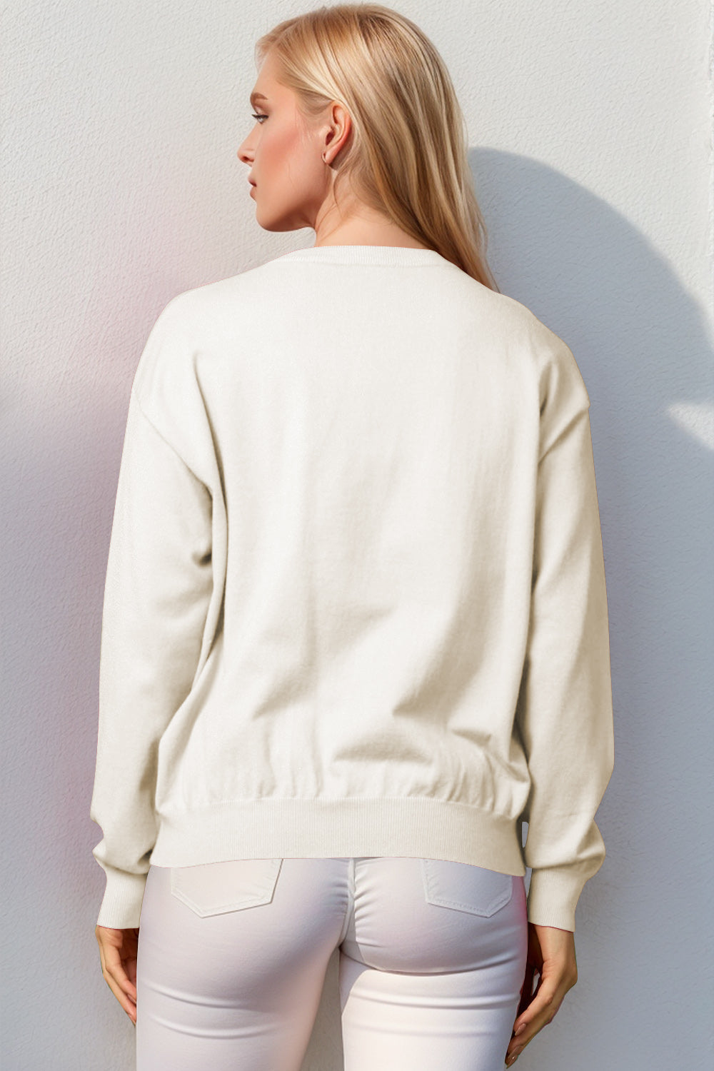 Ivory crewneck sweater with ribbed cuffs and hem, acrylic knit, back view.
