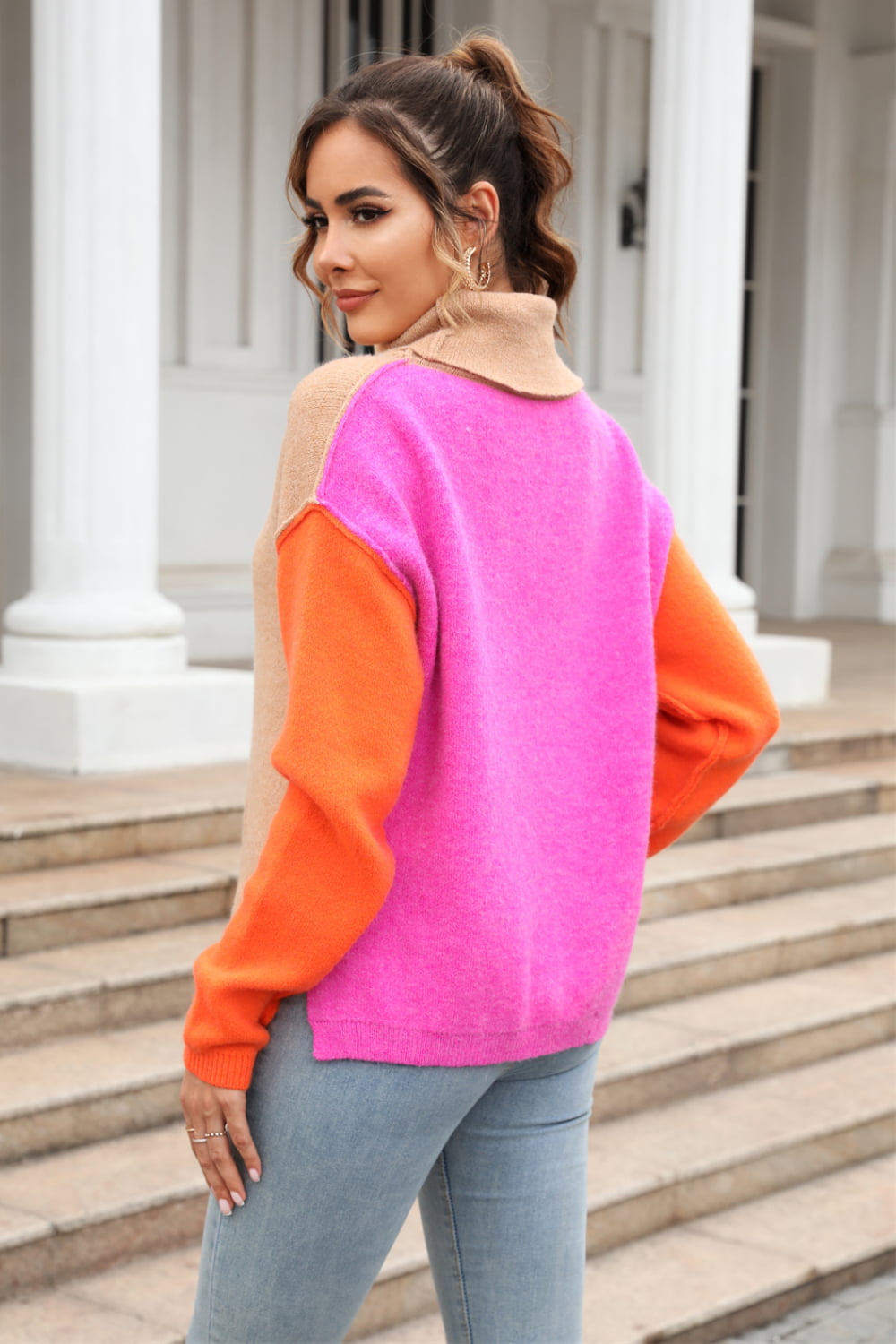 Colorblock turtleneck sweater with asymmetric hem in khaki, pink, and orange.