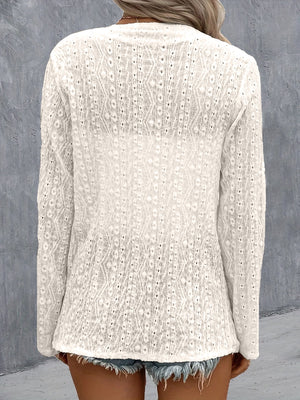 White open-weave cardigan with long sleeves and a diamond pattern, styled casually.