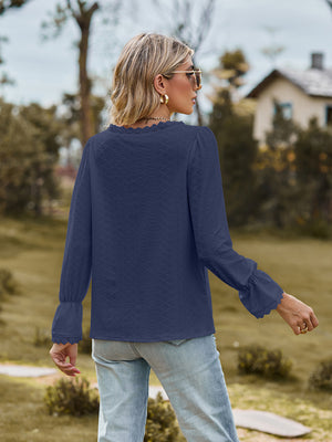 Navy textured blouse with lace trim neckline and flared cuffs.