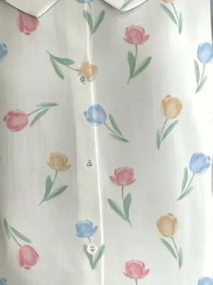 Peter Pan collar blouse with a floral tulip print in pink, blue, and yellow on a white background.