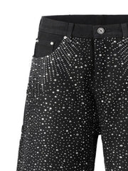 Black denim bermuda shorts with allover crystal burst embellishment.
