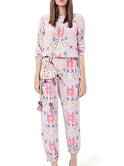 Women's blush pink abstract print lounge set with crew neck top and jogger pants.