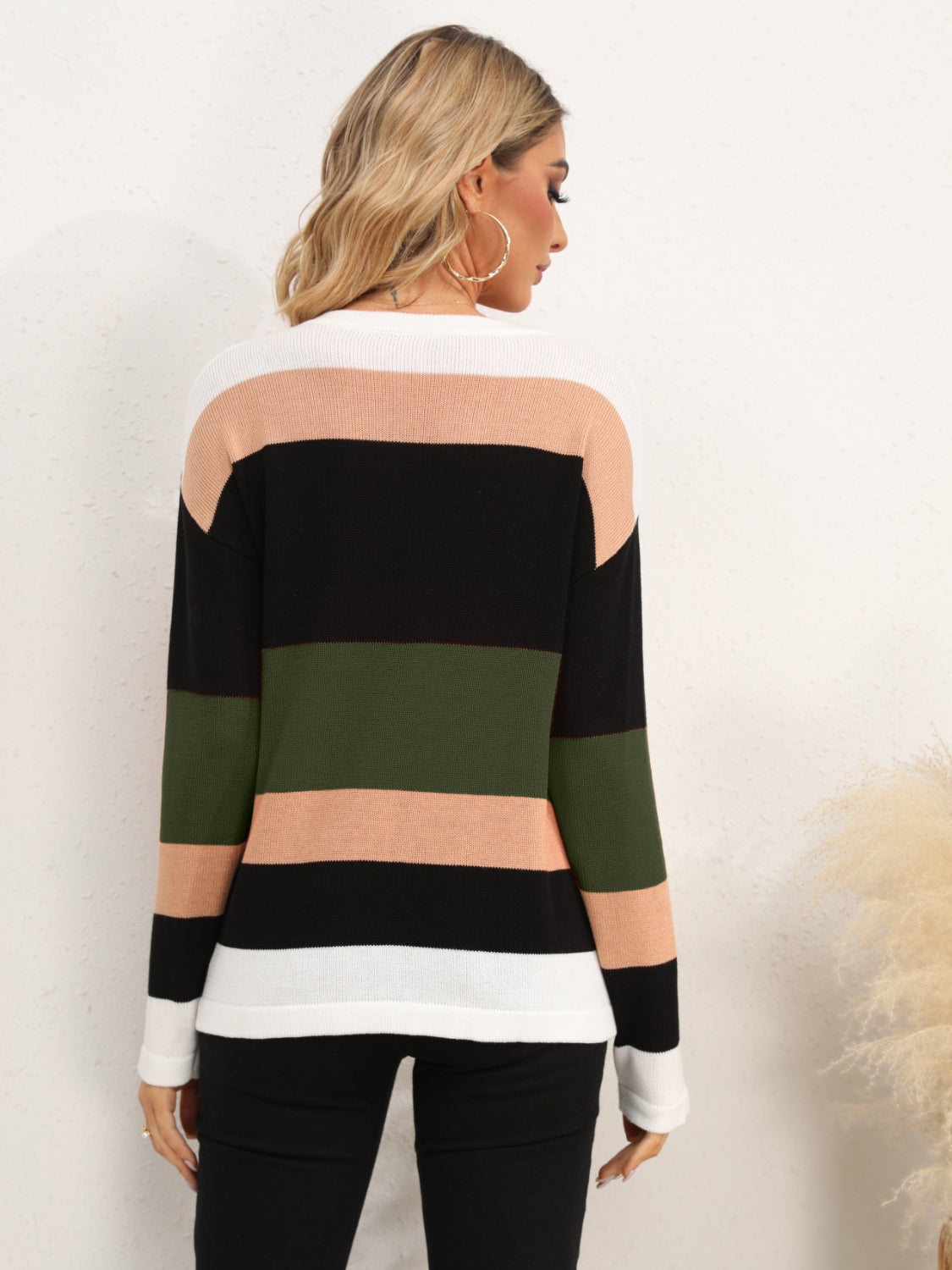 Colorblock crewneck sweater with horizontal stripes in black, army green, peach, and white.