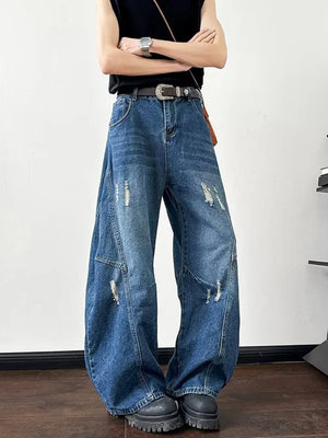 Distressed dark blue wide-leg jeans with ankle length and casual styling.