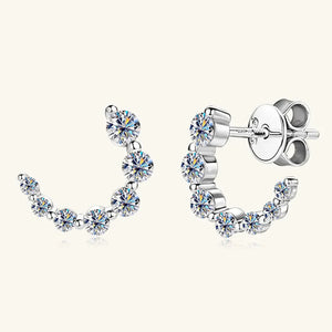 Silver moissanite arc stud earrings with sparkling cubic zirconia accents.