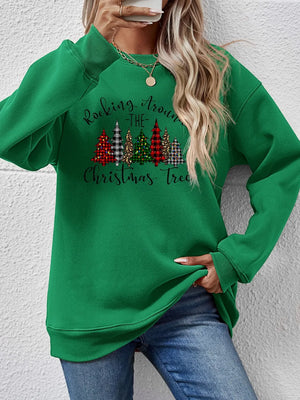 Green crewneck sweatshirt with graphic Christmas trees and text.