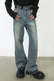 Distressed wide-leg jeans in medium wash denim with a raw hem and faded details.