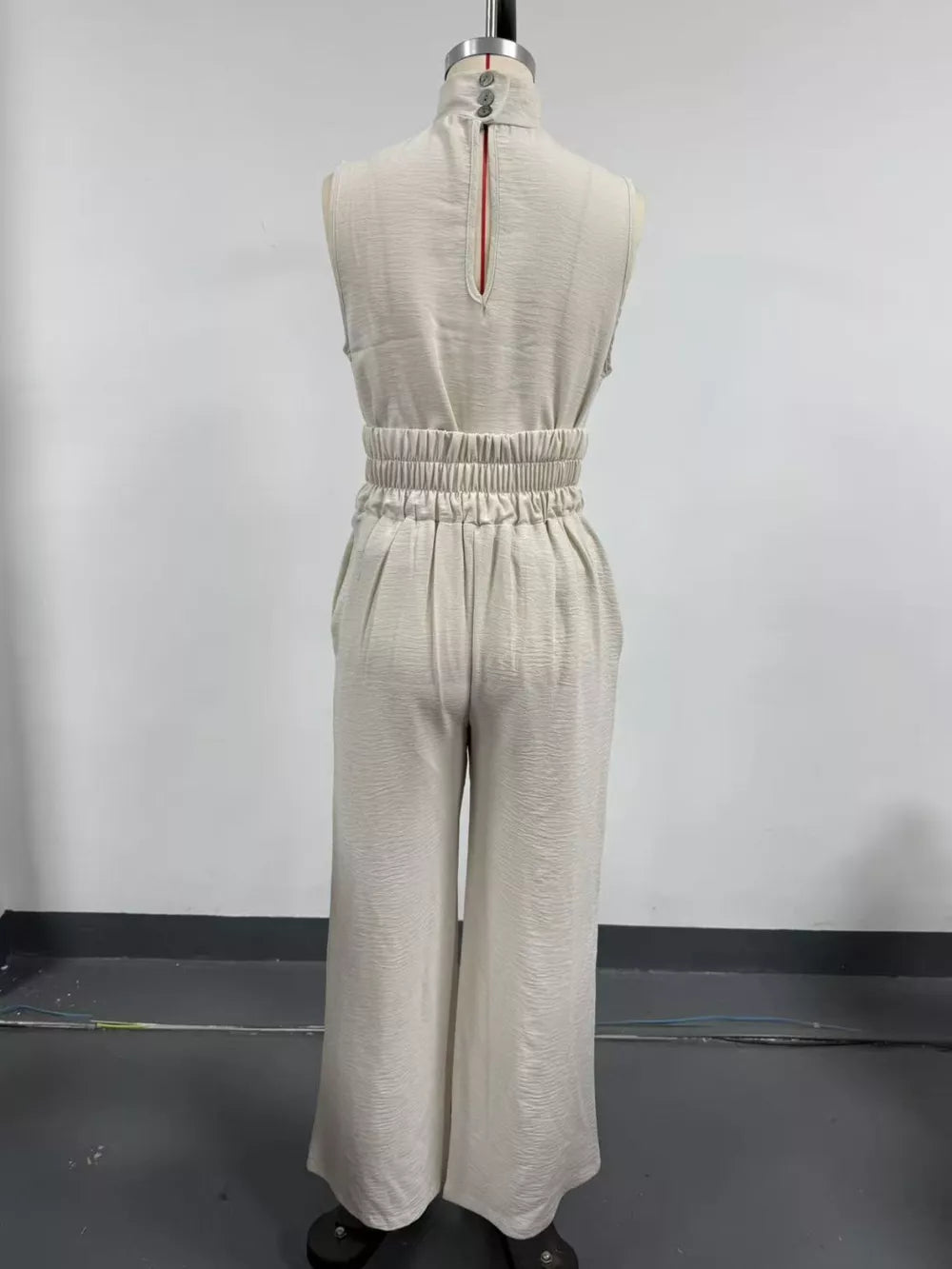 Sleeveless Wide-leg Jumpsuit With Smocked Waist in Apricot, model styling view