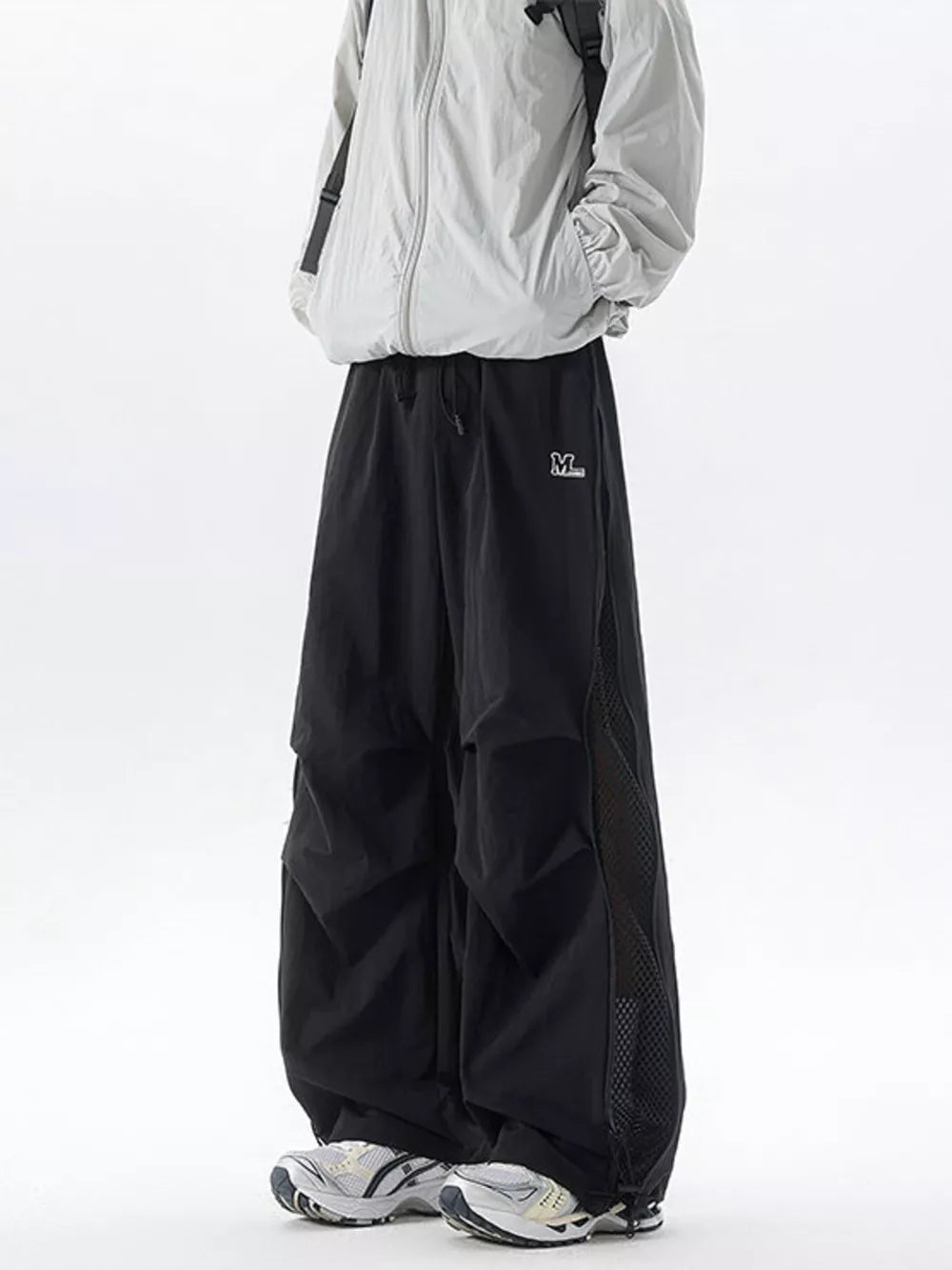 Black cargo sweatpants with adjustable waist and mesh panel detail