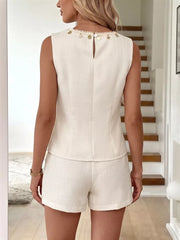 Embellished linen two-piece set with round neckline, sleeveless top, and shorts.