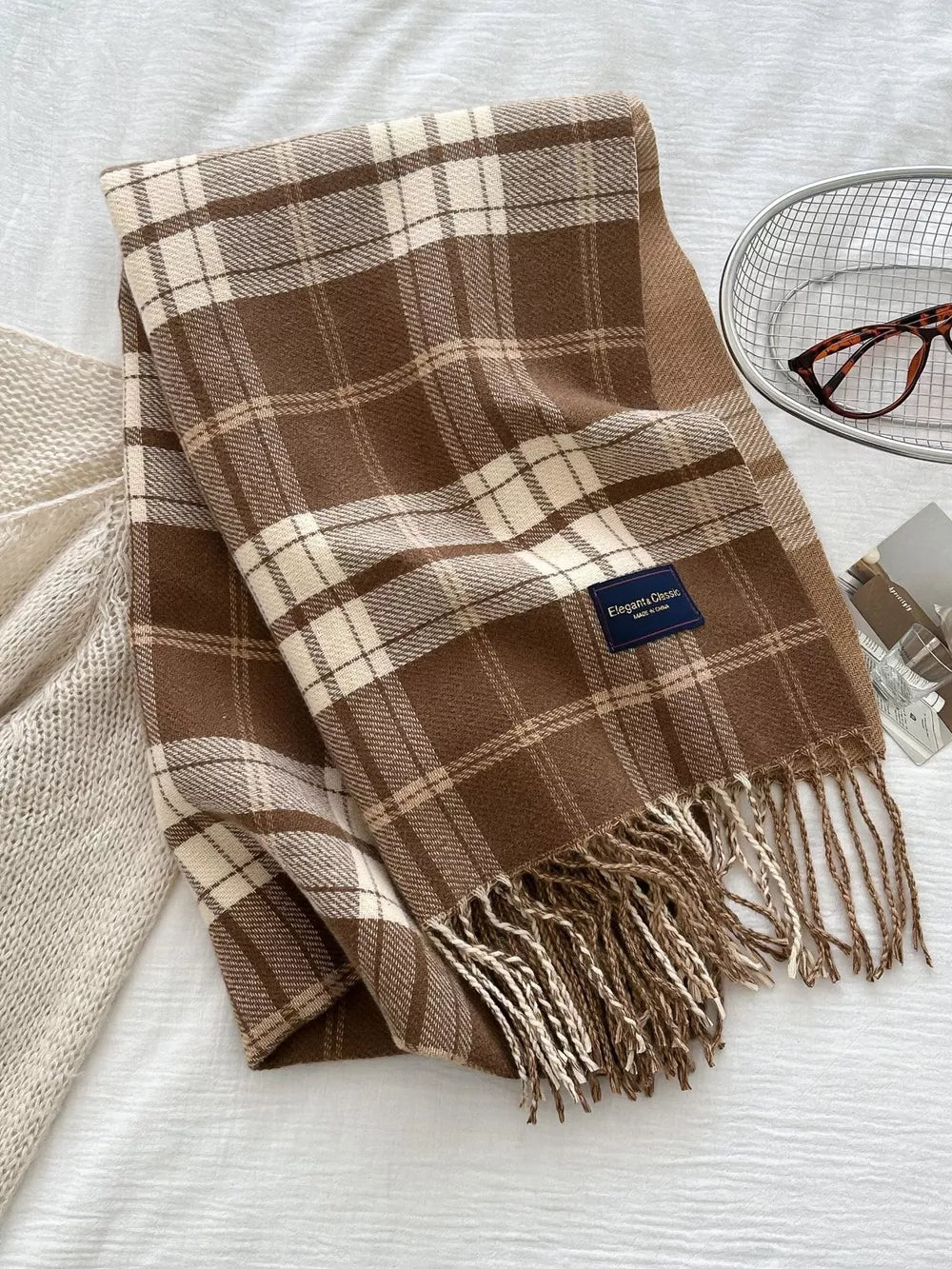 Brown plaid scarf with fringe detail and a cozy feel.