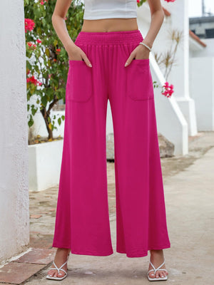 Hot Pink elastic waist palazzo trousers with pockets and wide legs.