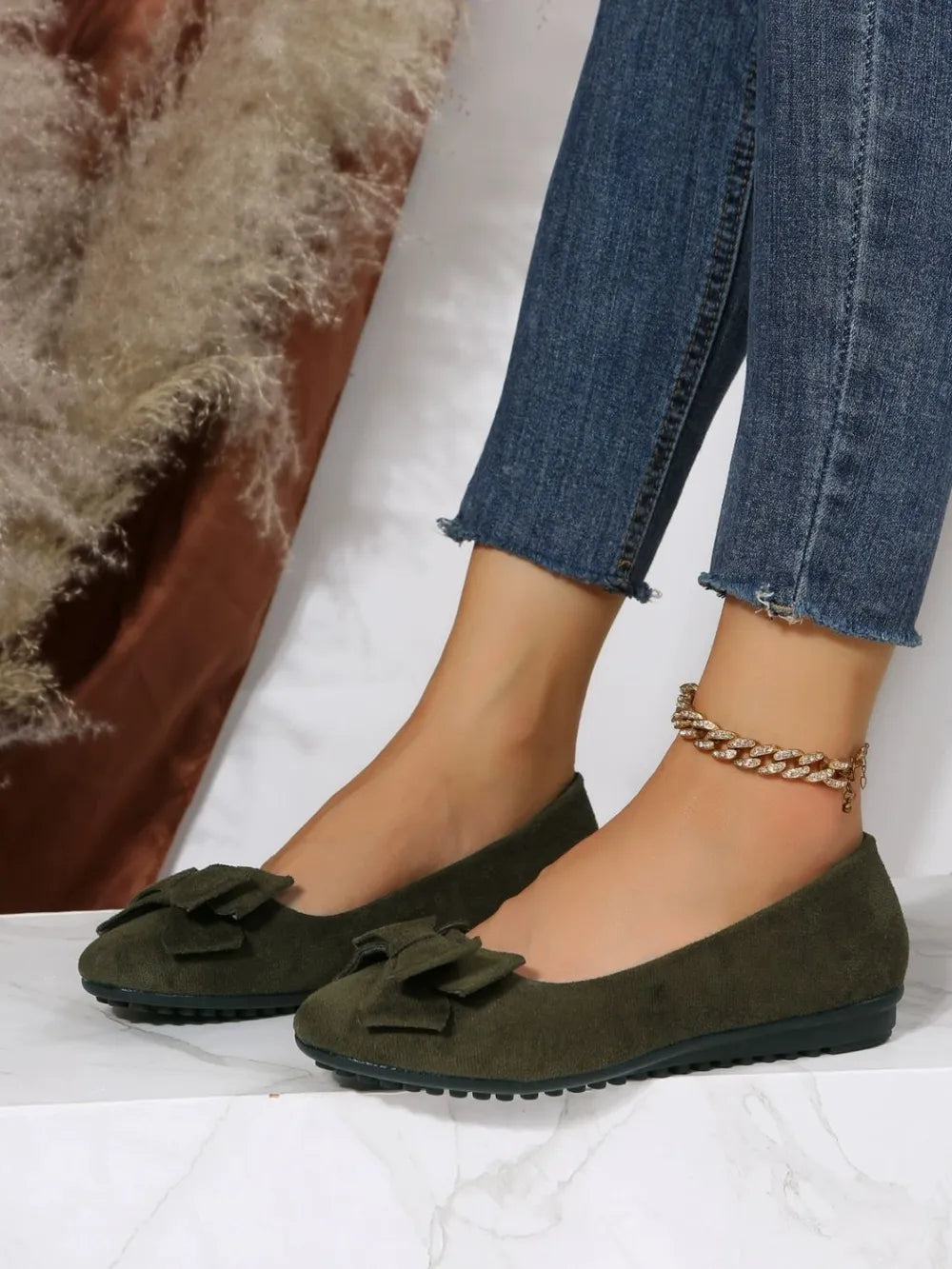 Moss suede pointed-toe flats with bow embellishment and ankle bracelet.