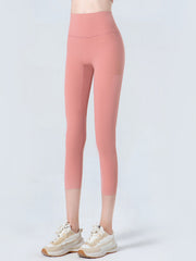 Sculpted crop leggings in coral with subtle mesh detail on the side.