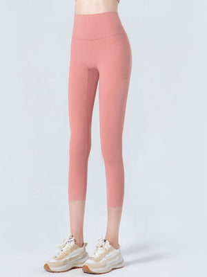 Sculpted crop leggings in coral with subtle mesh detail on the side.