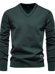 Essential V-neck ribbed knit sweater in Peacock Blue with a ribbed hem and cuffs.