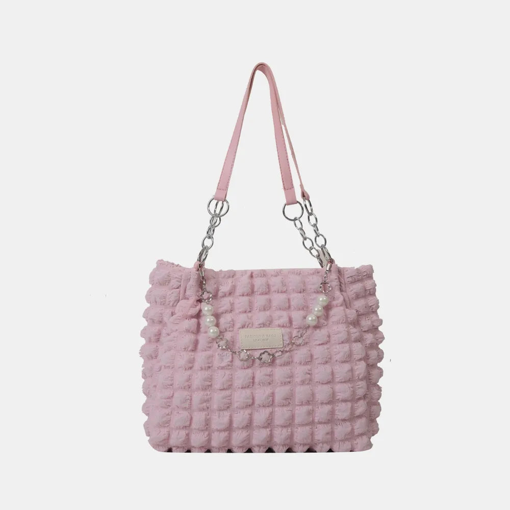 Blush pink textured shopper bag with pearl chain detail and silver hardware.