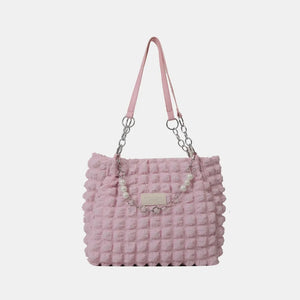 Blush pink textured shopper bag with pearl chain detail and silver hardware.