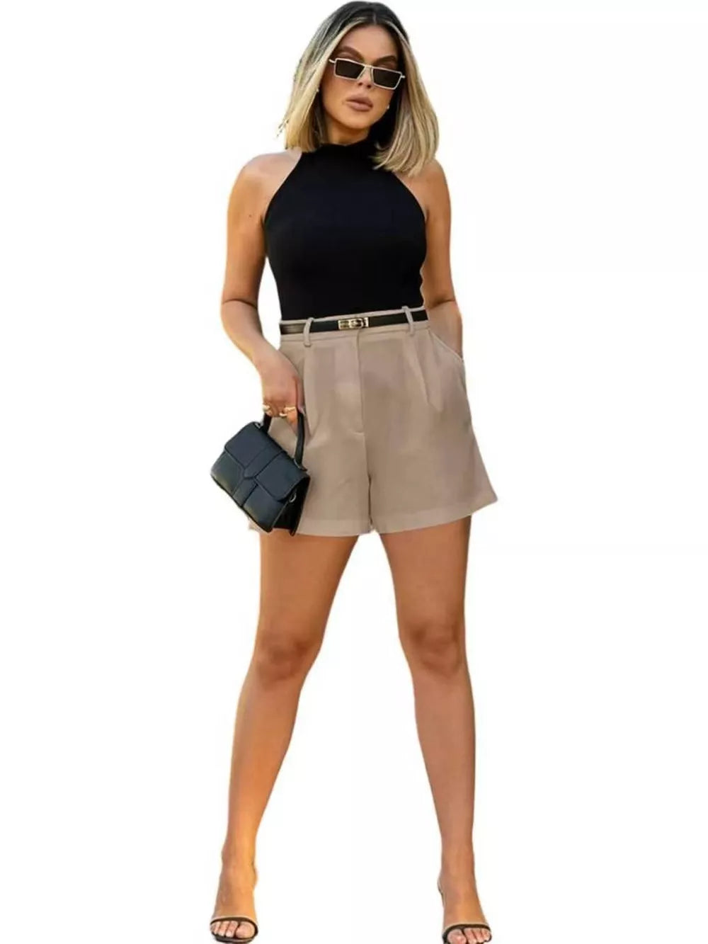 Khaki high-waisted shorts with pleats and pockets, styled with a black top and belt.