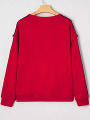 Red sweatshirt with varsity stripe detail on sleeves and neckline