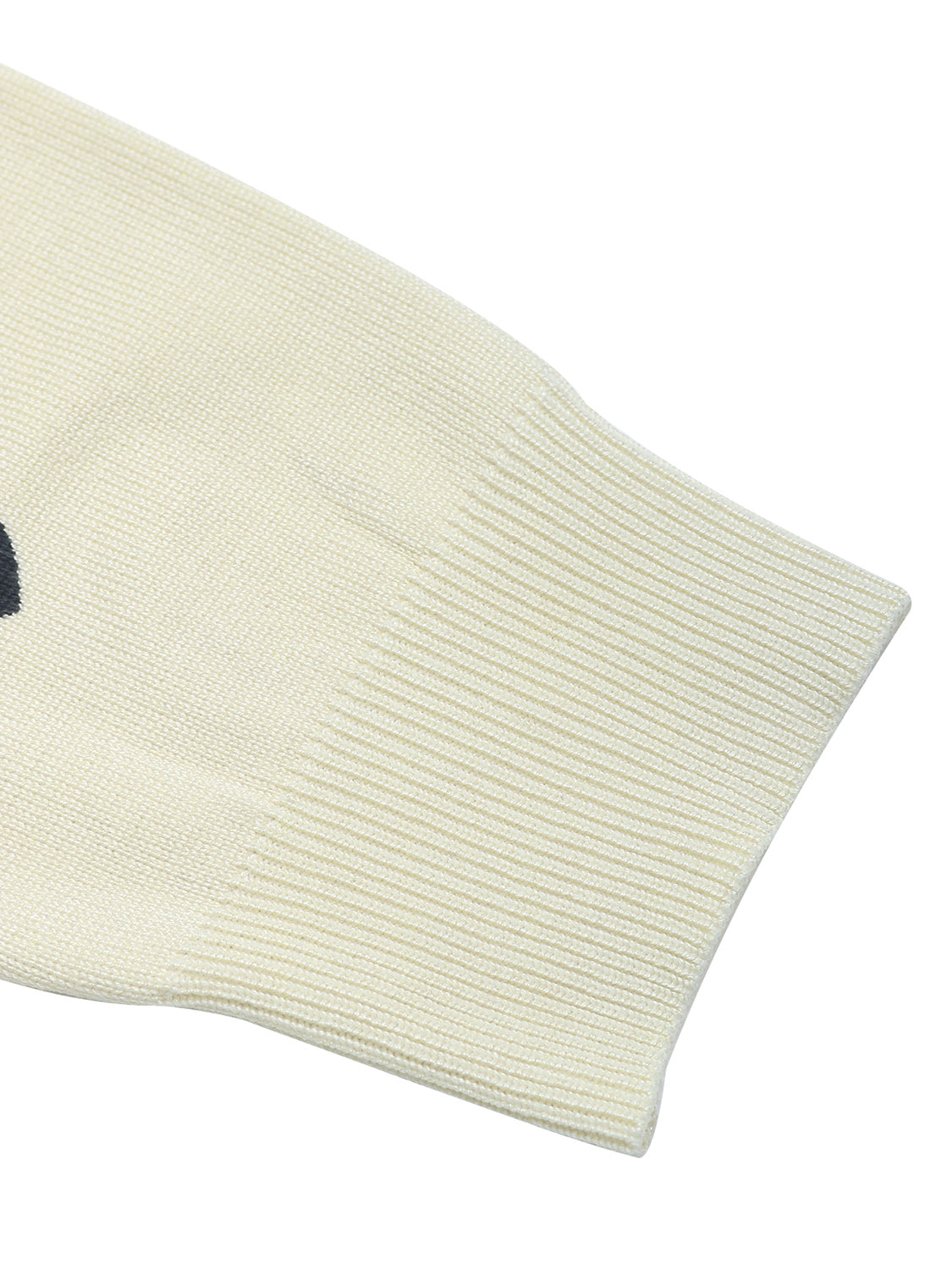 Cream acrylic knit sweater with scattered heart intarsia pattern and ribbed cuffs.
