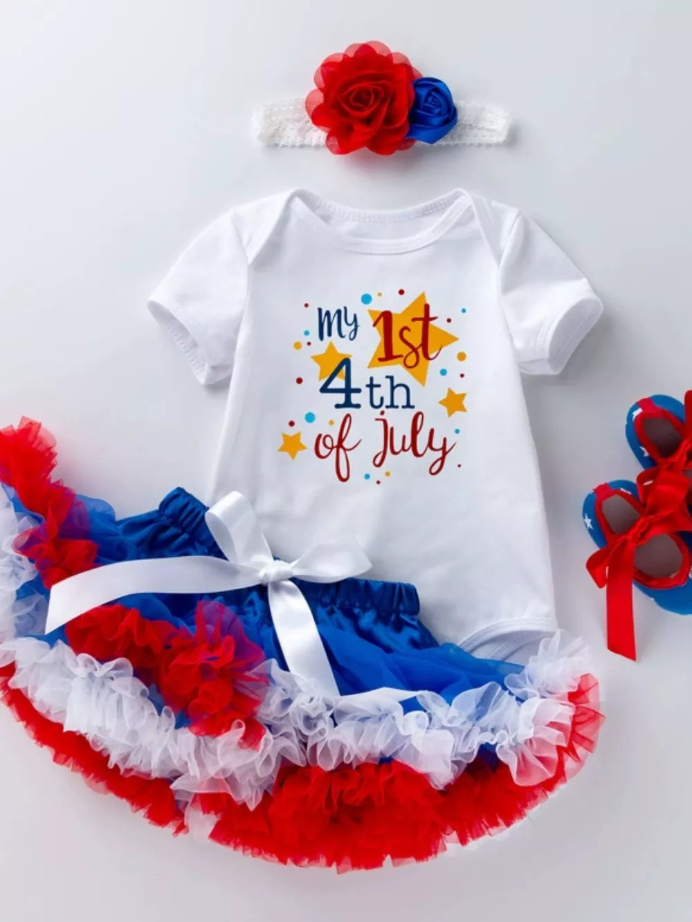 Patriotic baby outfit with "my 1st 4th of July" bodysuit, ruffled tutu, and headband.