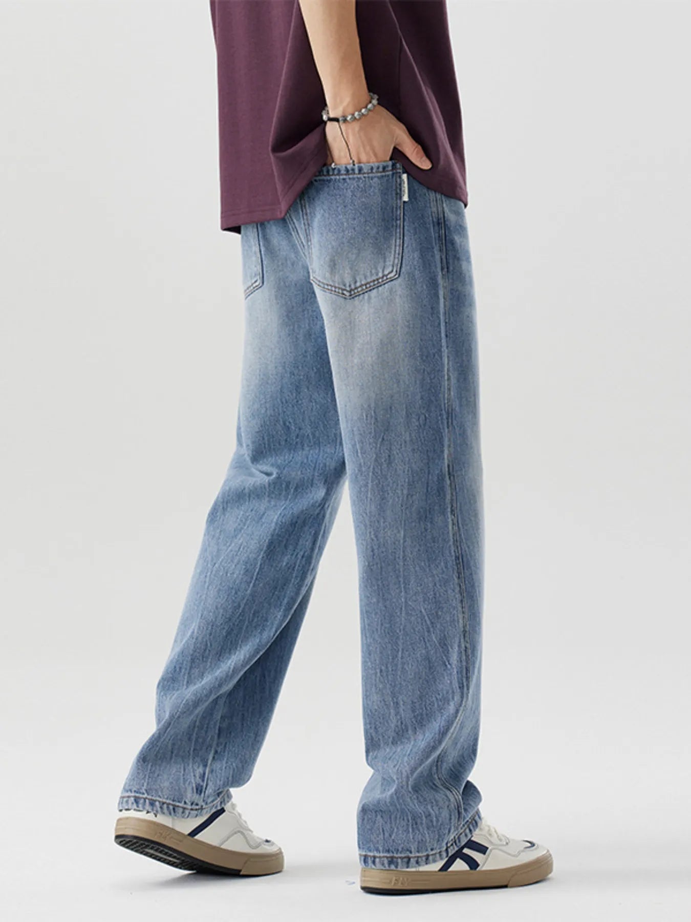 Men's relaxed fit blue washed cotton jeans with a casual style.