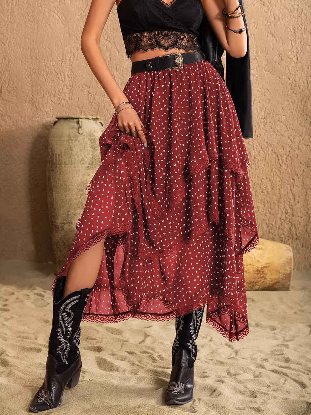 Burgundy polka dot tiered midi skirt with lace trim and a flowy silhouette.