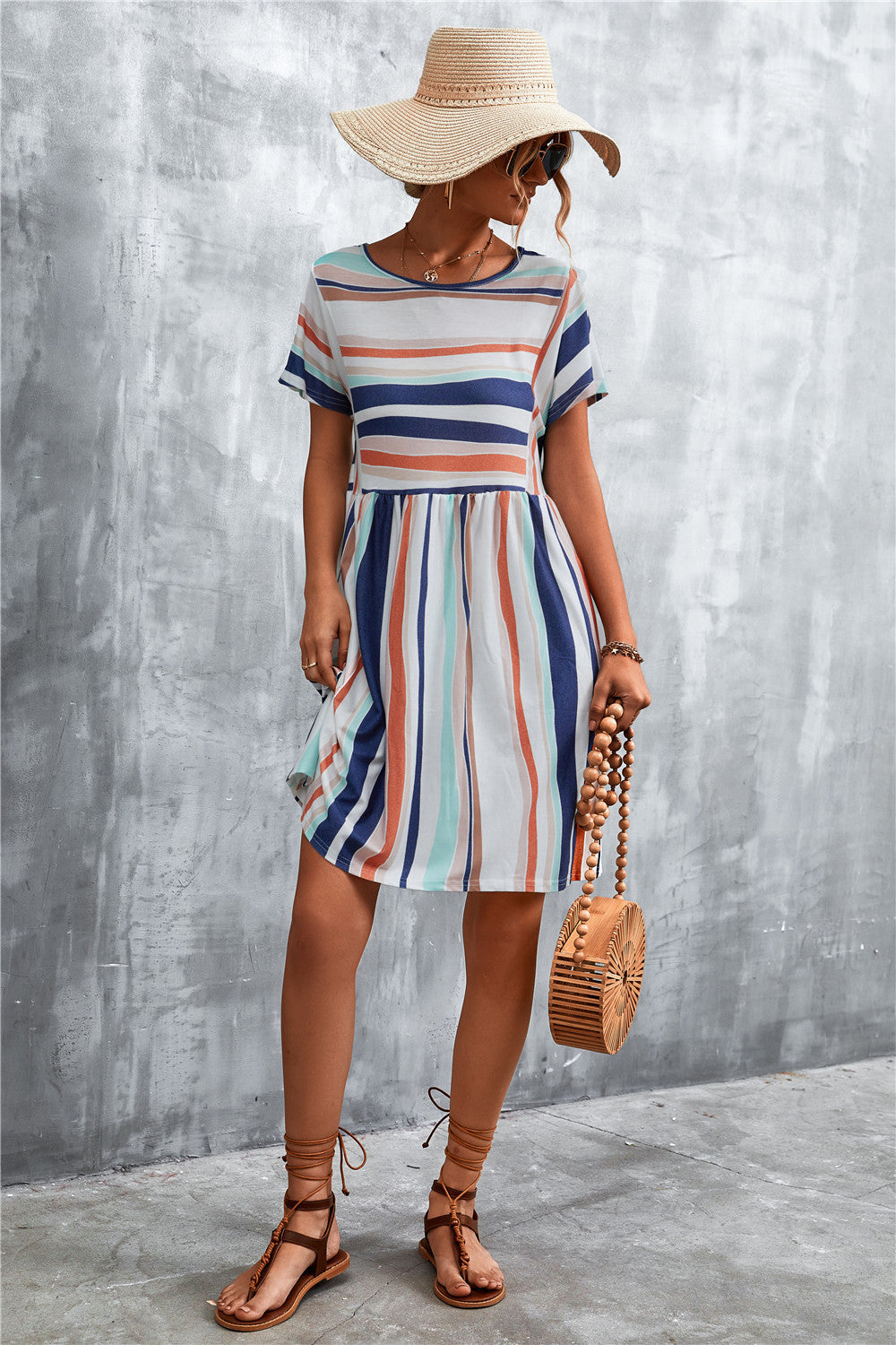 Striped trapeze dress with short sleeves and yoke seam detail, in multi-color stripes.
