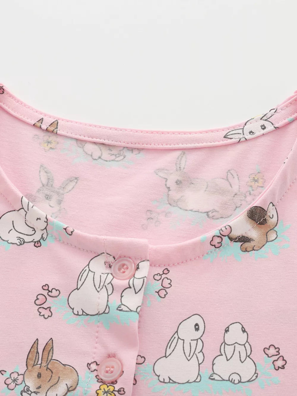 Pink cotton toddler dress with bunny print and button front detail.