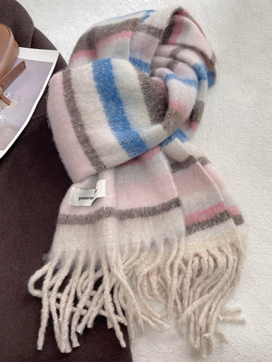 Plush multi-patterned scarf with pink, blue, and brown stripes and fringe details.