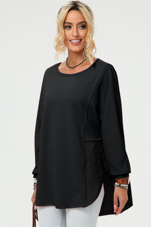 Black split-panel sweatshirt with asymmetric hem and textured side panel detail.