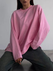 Pink oversized crewneck sweatshirt with voluminous sleeves and a relaxed fit.