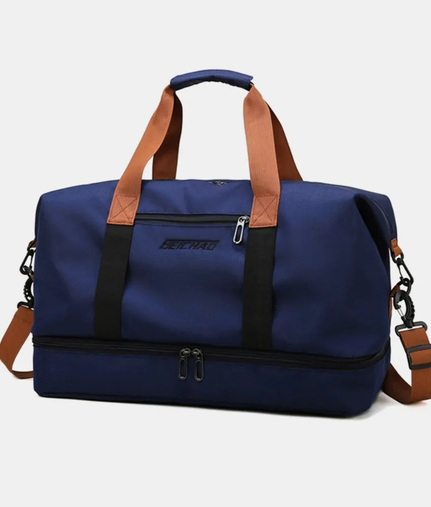 Dark Navy dual-compartment weekender bag with contrast brown and black straps and dual zippers on the bottom compartment.