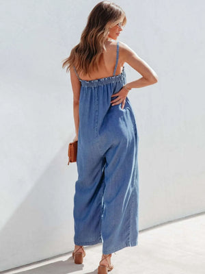 Medium denim jumpsuit with gathered bodice and wide legs.
