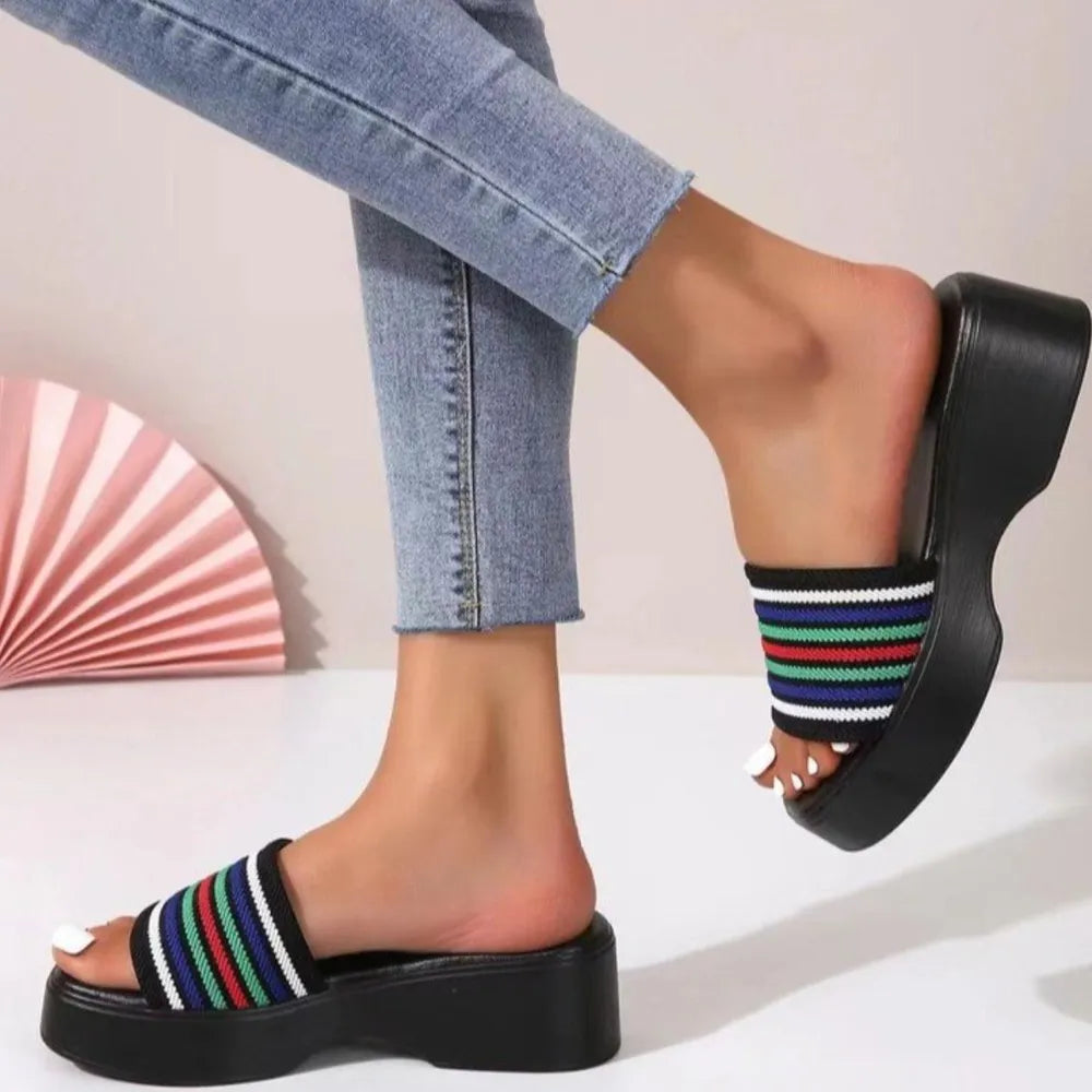 Platform knit slide sandals in Stripe pattern with black sole and multi-colored striped band.