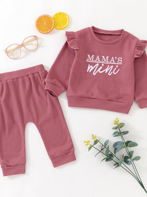 Toddler dusty rose waffle knit top with ruffled sleeves and "Mama's Mini" graphic, paired with matching pants.